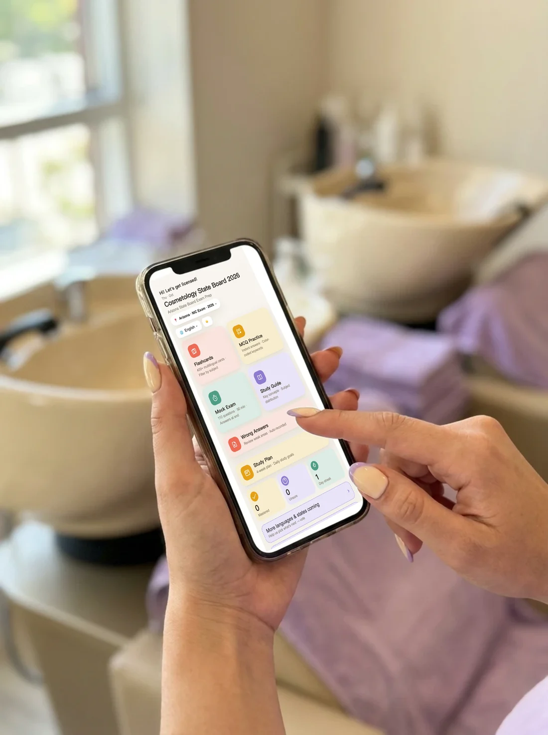 CosmoPass open on a phone in a salon, showing flashcards, practice questions, mock exam and study plan